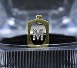 EN MERLIOT VENDO DIJE ORO 18KT, LETRA M